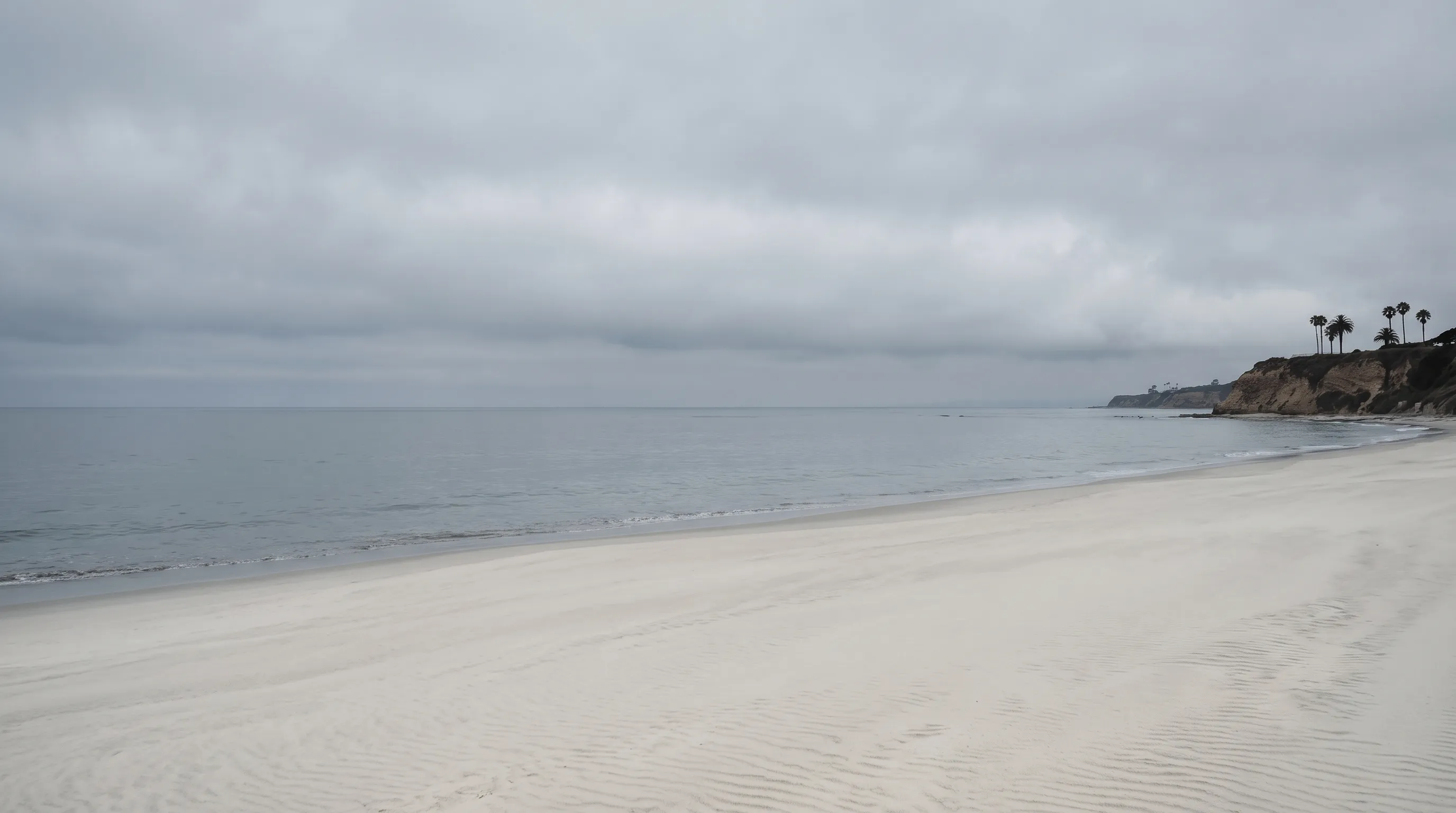 Overcast San Diego coastline under a bright marine layer